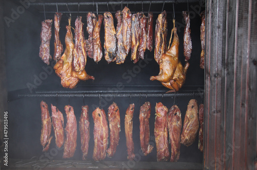 Smoking meat and chicken in a wood-fired oven. Meat delicacies.
