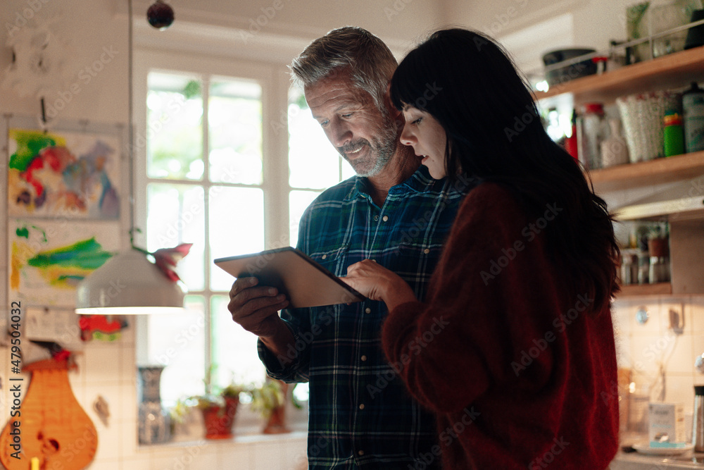 Heterosexual couple using digital tablet at home Heterosexual couple using digital tablet at home