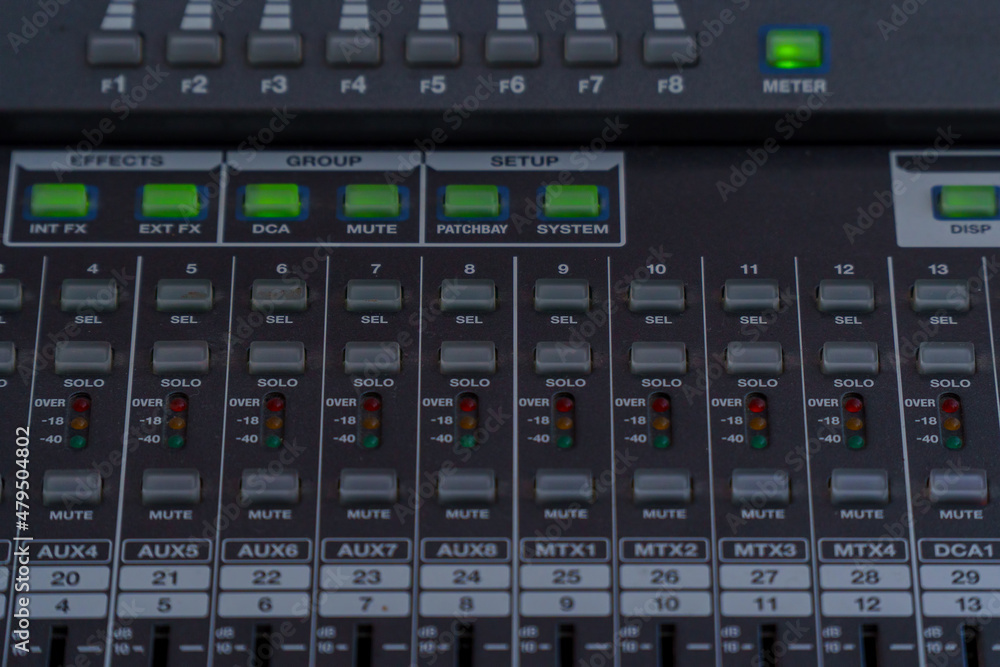 Control buttons and LED indicators on the mixing console. Selective focus