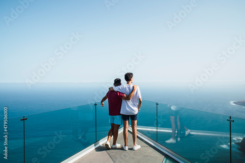 Young friends with arms around looking at sea from Mirador Del Balcon, Grand Canary, Canary Islands, Spain