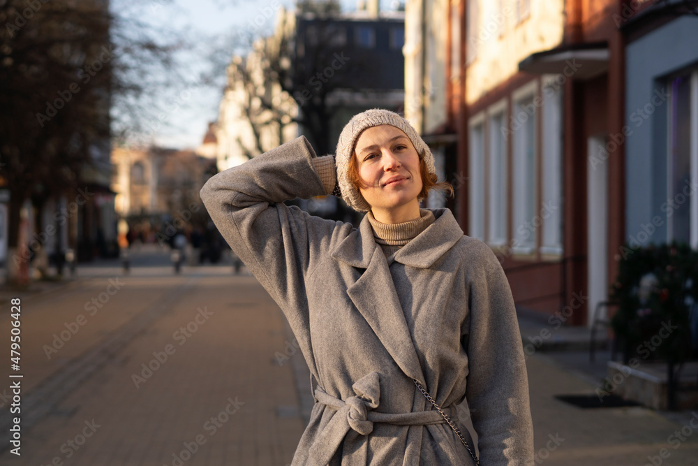 Young woman with hand behind head on street Young woman with hand behind head on street