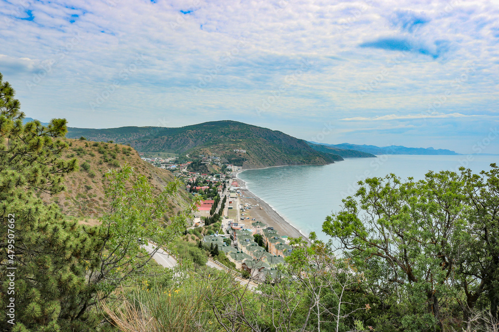 Fototapeta premium View from the mountain to the village of Rybachye and a beautiful bay with azure water, Crimea.