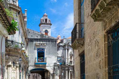 Street in the historical center of the old havana near the Church of St. Christopher, background church and bell tower of cathedral,Havana, Cuba. © robertobinetti70