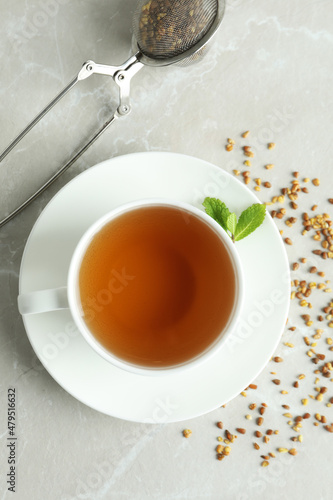 Concept of hot drink with buckwheat tea on light textured table