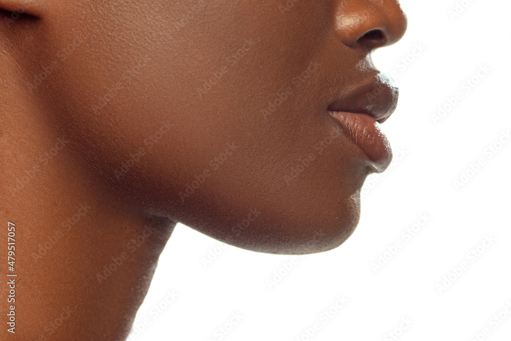 Close- up face of young african woman with well-kept skin isolated on white studio background. Details. Close- up face of young african woman with well-kept skin isolated on white studio background. Details.