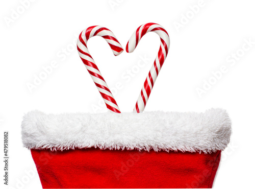 Heart candy canes in red christmas stocking isolated on white background