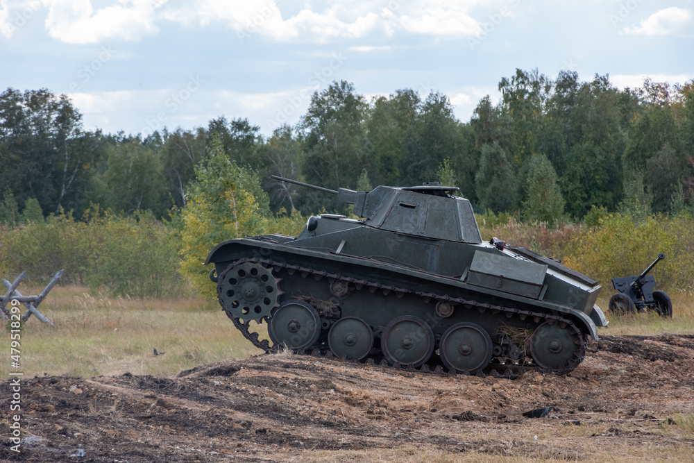 Attack of the Soviet tank T25. Tank moving through the fortification, ditch. Reconstruction of the battle of World War II. Russia, Chelyabinsk region, September 12, 2021 Victory Day. Attack of the Soviet tank T25. Tank moving through the fortification, ditch. Reconstruction of the battle of World War II. Russia, Chelyabinsk region, September 12, 2021 Victory Day.