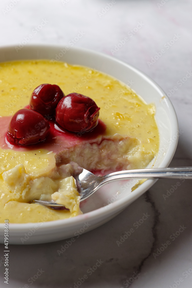 Vanilla flummery with cherries, in a porcelain bowl. Vanilla custard. Vanilla flummery with cherries, in a porcelain bowl. Vanilla custard.