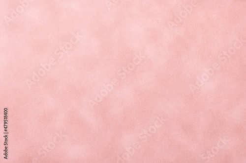 Texture of pink old paper, crumpled background. Vintage rose grunge surface. Matt velvet textile backdrop.