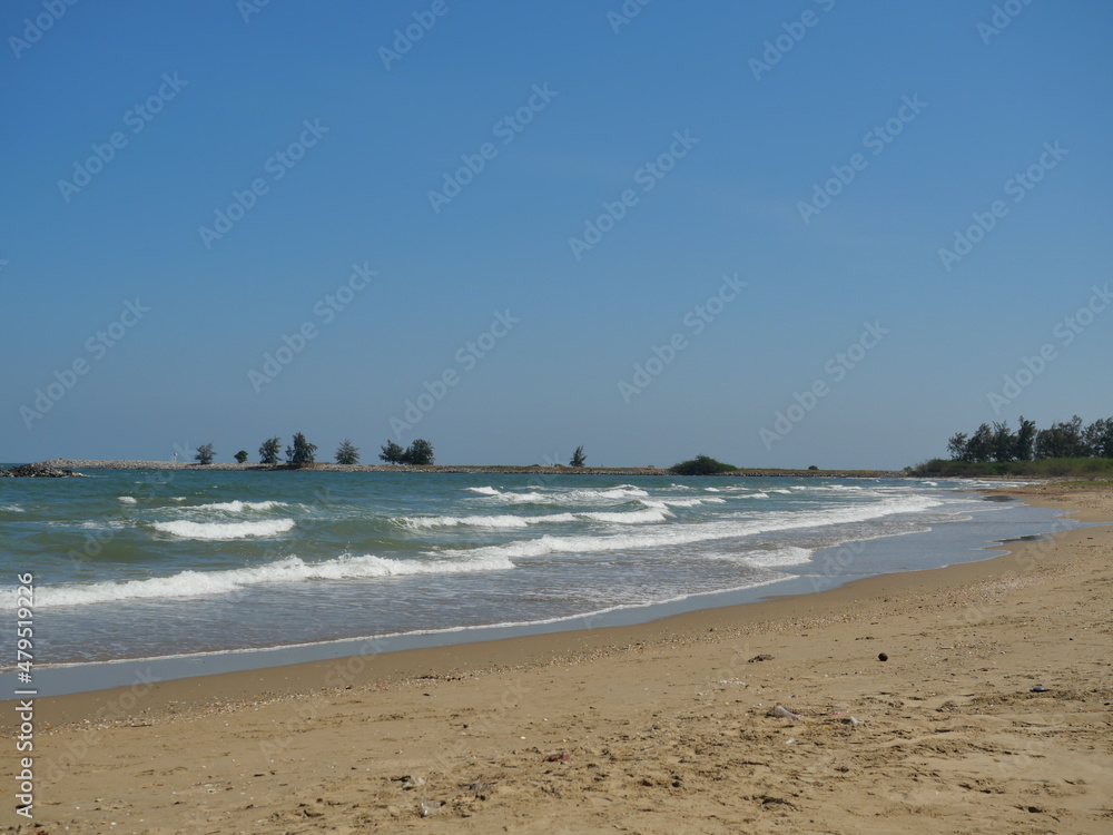 The beach with blue sky in background, Wave in the sea were violently hitting the shore at Pranburi Forest Park, Thailand	