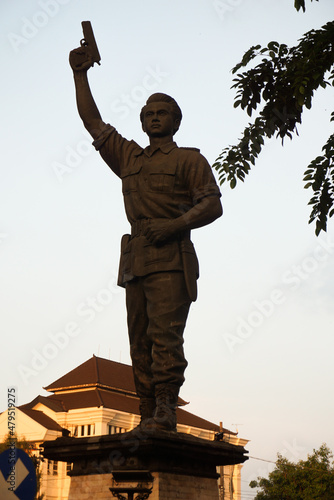 Surakarta, Indonesia – December 20, 2021: Gladak Statue or the Slamet Riyadi Statue is a form of appreciation to Captain Slamet Riyadi in the city of Solo in the afternoon. Jalan Tugu Slamet Riyadi photo