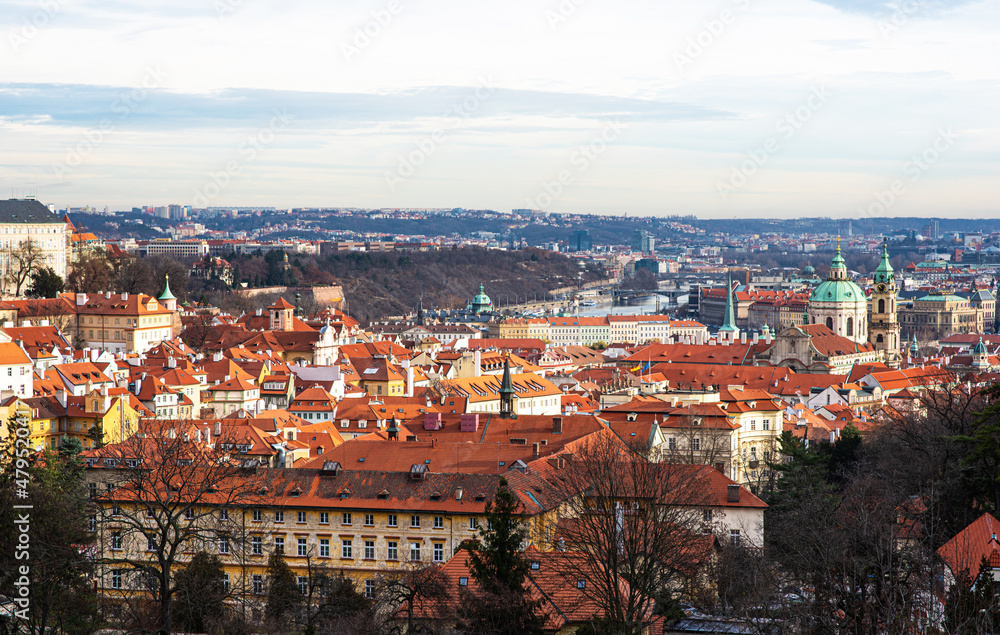 Prague city view with historical buildings. Scenic aerial view of the Old Town architecture. Picturesque landscape with old houses with red tiled roofs.