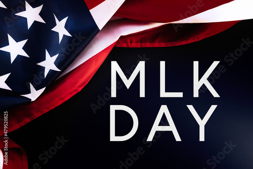 Obraz na plátně Black background and American Flag with text abbreviation MLK