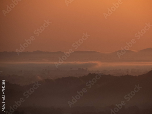 Amazing Sunrise Over Misty Landscape. Scenic View Of Foggy Morning Sky With Rising Sun Above Misty Forest