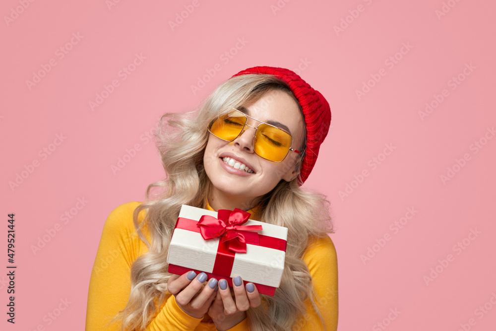Cheerful woman with gift box in studio Cheerful woman with gift box in studio