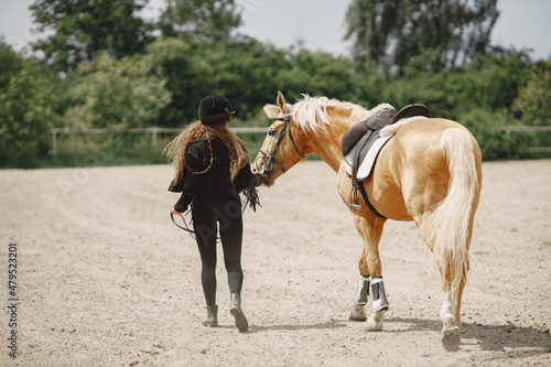 Portrait of riding horse with woman in black helmet © hetmanstock2