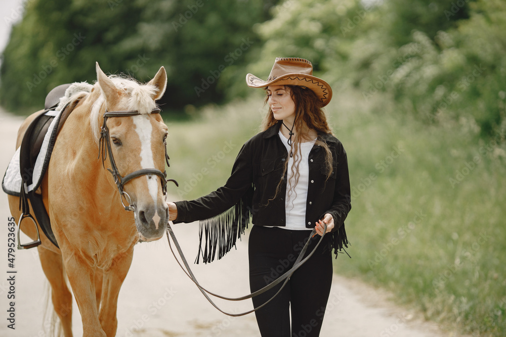 Portrait of woman in brown leather hat with a horse