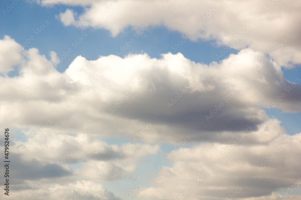 Fototapeta premium Cumulus clouds, gentle air clouds in the blue sky on the sunrise
