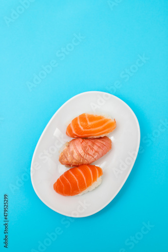 Assorted sushi on small white dish top view