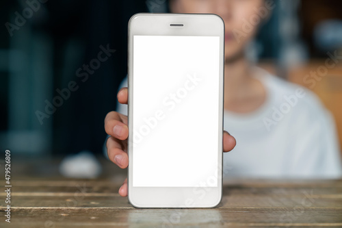 Woman hand holding smartphone and the screen is blank, social network concept, copy space for your advertising..