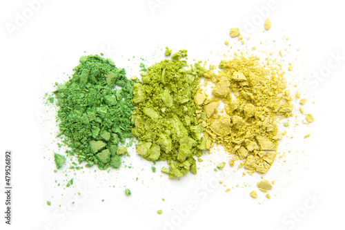 Green and yellow colorful eye shadow, crushed cosmetic isolated on white background. A smashed, bright toned eyeshadow make up palette