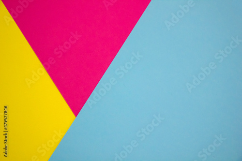 Blue, yellow and pink paper color for background. Geometric pattern, minimalism texture shapes