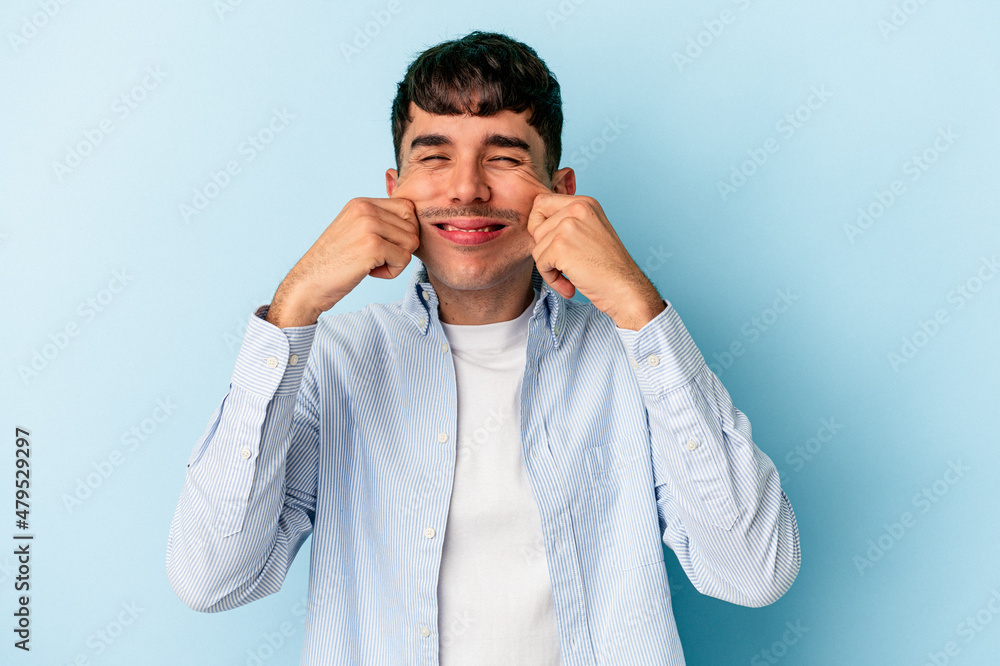 Young mixed race man isolated on blue background doubting between two options. Young mixed race man isolated on blue background doubting between two options.