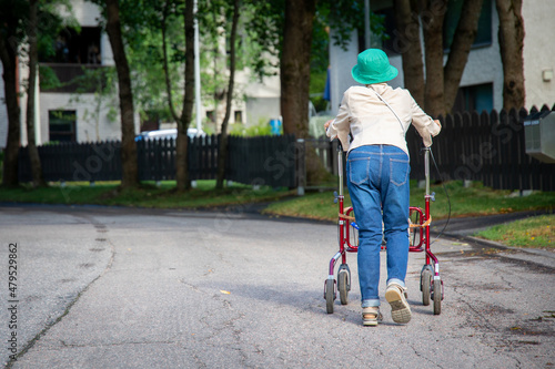 Photos Old woman walking with rollator