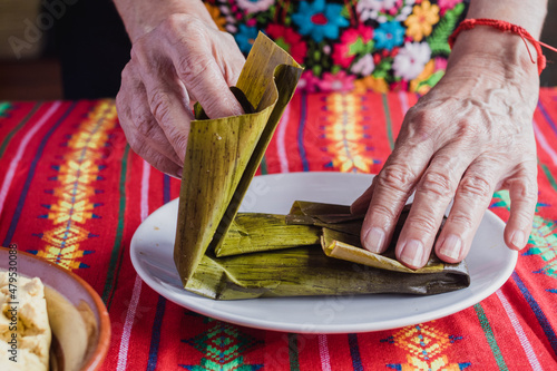 Photography mexican woman elaborating Oaxaca tamales for Candlemas festivity