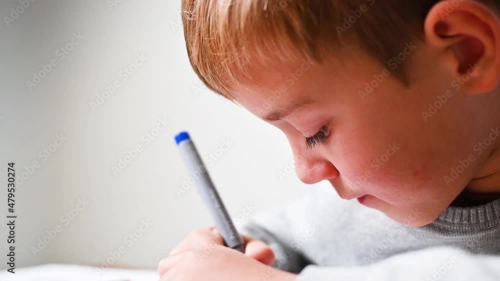 Boy draws using pen, close up Boy draws using pen, close up
