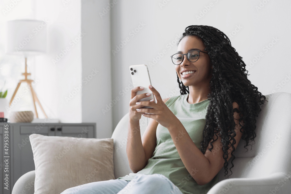 Side View Pleasant Millennial Mixed Race Woman Holding Smartphone
