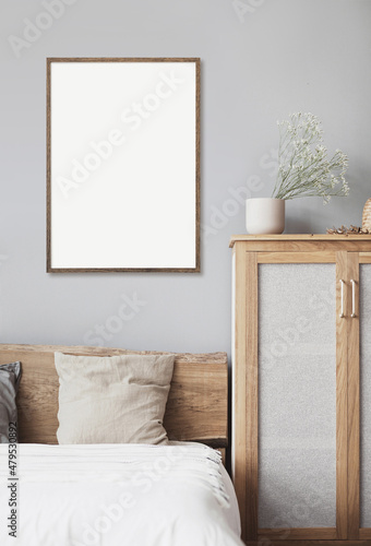 Blank picture frame mockup on gray wall. White living room design. View of modern scandinavian style interior with artwork mock up on wall. Home staging and minimalism concept © kite_rin