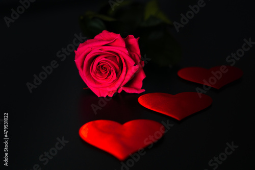 Flower and hearts on a black background