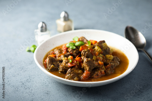 Fotografi Beef ragout with vegetables and basil