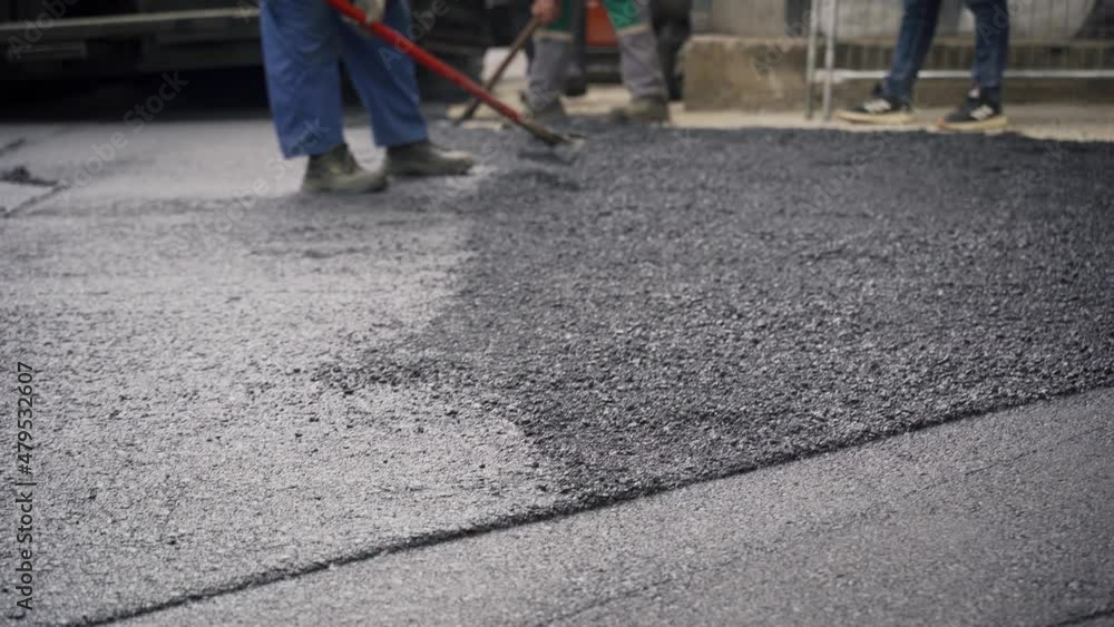 Workers Laying Asphalt and Straightening it for a New Road Infrastructure Project, Handheld Workers Laying Asphalt and Straightening it for a New Road Infrastructure Project, Handheld