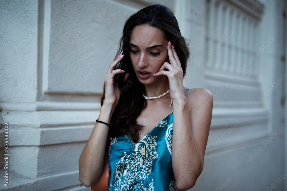 Beautiful young elegance woman using the phone. Beautiful fashion woman talking to the phone..