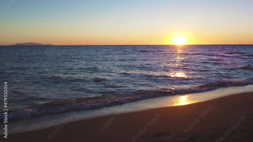 Sunset at Maremma National Park in Tuscany, Italy. 4K UHD aerial drone footage of pine tree forest and beach seaside ocean coast with an island in the distance and blue sky and water in the evening. Sunset at Maremma National Park in Tuscany, Italy. 4K UHD aerial drone footage of pine tree forest and beach seaside ocean coast with an island in the distance and blue sky and water in the evening.