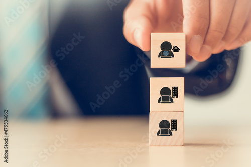 Gig economy, freelance, hybrid workplace concept. The combination of employment trend; growing to external hiring. Businessman puts wooden cubes with gig economy icon on smart background, copy space. photo