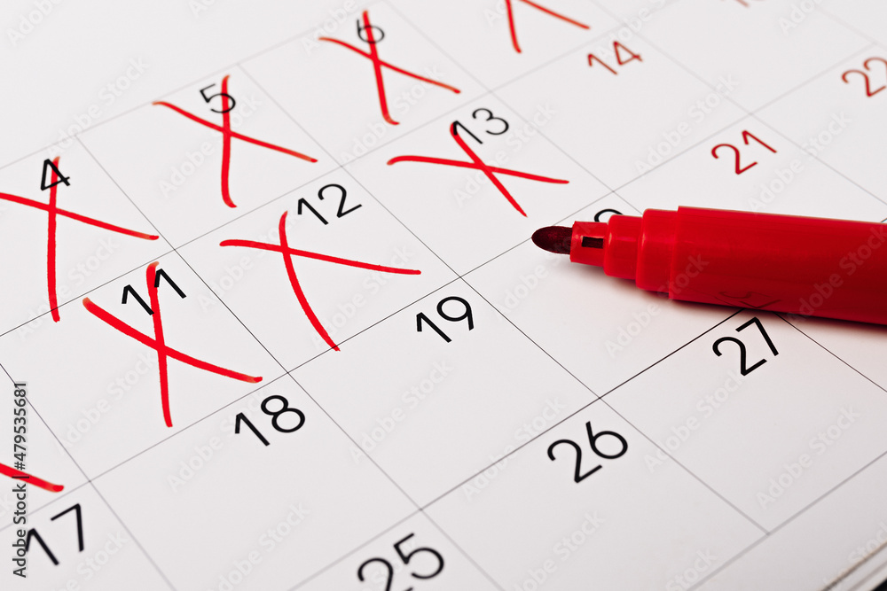 close up of a calendar page with red pen close up of a calendar page with red pen