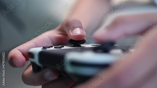 Boy playing video game using joystick, close up