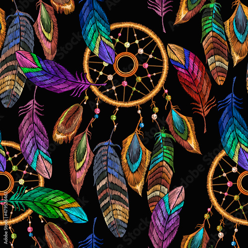 Embroidery dream catcher and feathersseamless pattern. Native american indian talisman. Magic tribal  background, t-shirt design. Template for clothes ethnic style
