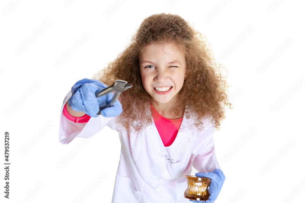 Studio shot of cute little girl, child in image of dentist doctor wearing white lab coat and gloves isolated on white studio background Studio shot of cute little girl, child in image of dentist doctor wearing white lab coat and gloves isolated on white studio background
