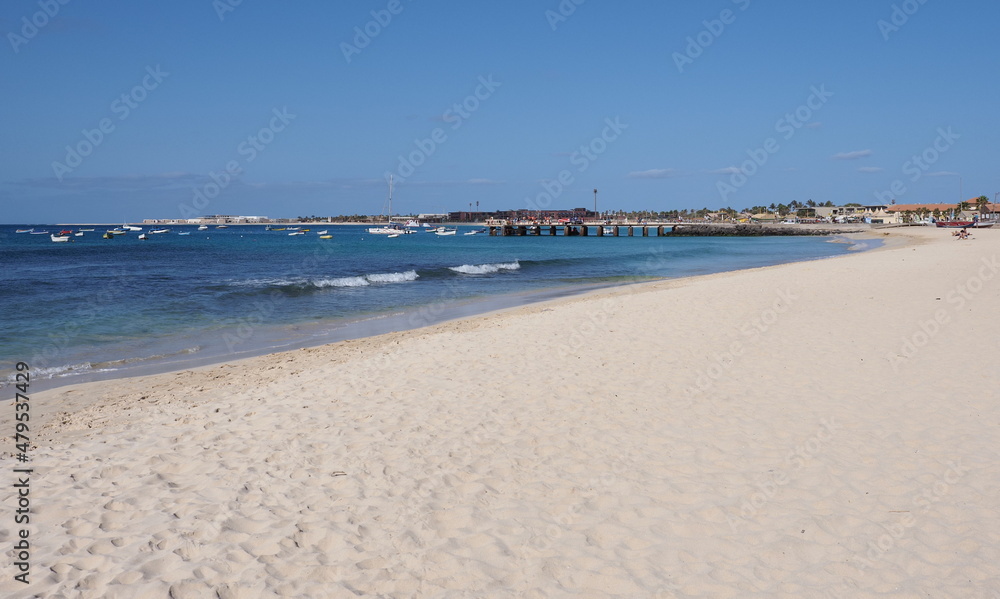 Sandy beach and wooden pier and boats in Sal island in Cape Verde Sandy beach and wooden pier and boats in Sal island in Cape Verde