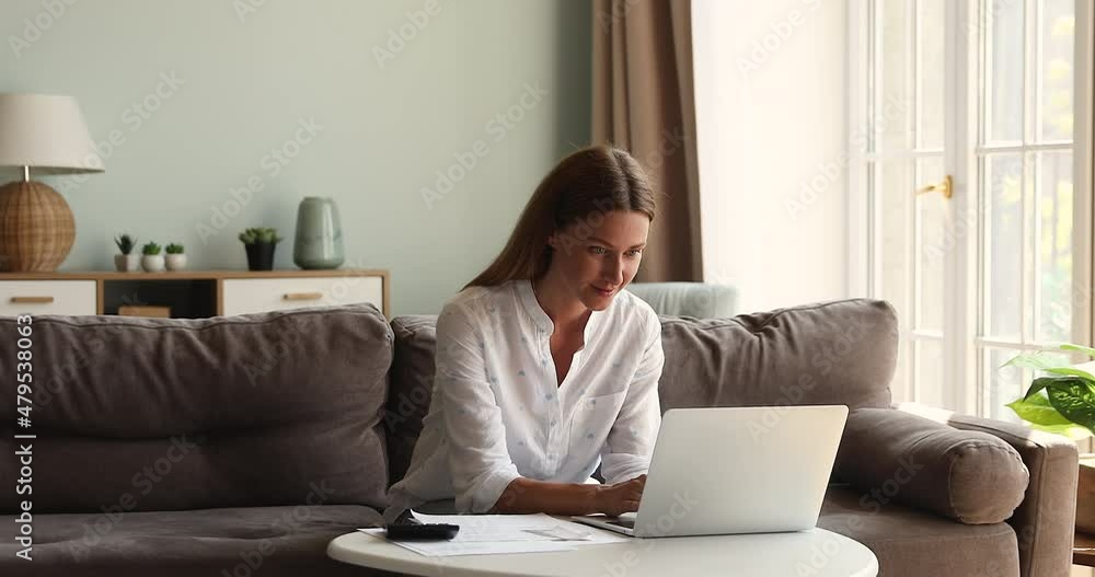 Confident young woman skilled accountant freelancer work with papers at home office make financial report plan monthly budget for client. Young lady homeowner calculate taxes bills make payment online Confident young woman skilled accountant freelancer work with papers at home office make financial report plan monthly budget for client. Young lady homeowner calculate taxes bills make payment online