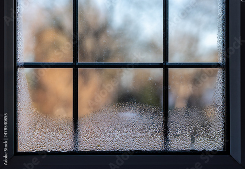 Close-up of a leaded double glazed window with condensation inside on after a very cold night photo