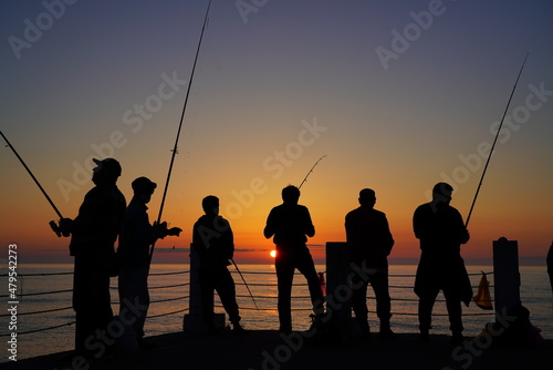 fishermen on the background of the sea sunset