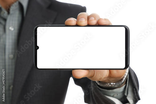 Close-up, businessman hand in suit holds smart phone and shows smartphone screen of mockup, place for advertising goods or copy space text