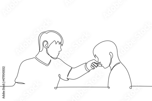 male nurse feeding with spoon to child or sick person - one line drawing vector. adult caregiver caring for person with disability, sick person or child