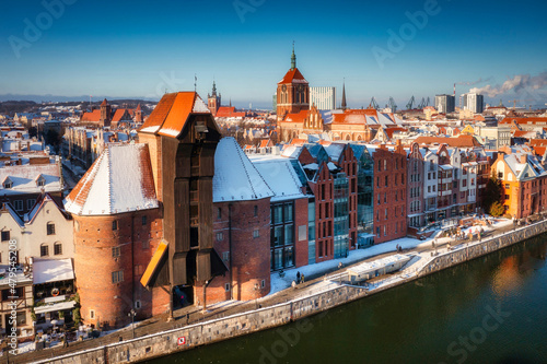 Medieval port crane in Gdansk over the Motlawa river at snowy winter, Poland
