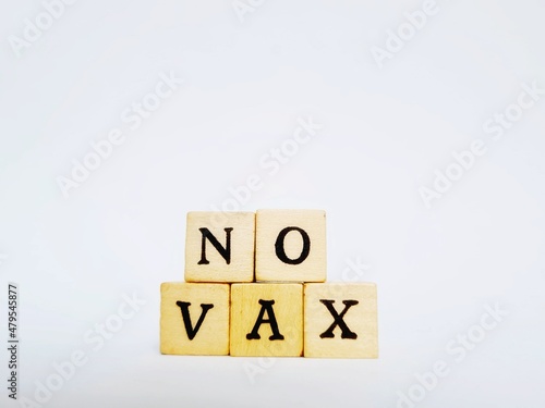 written no vax with wooden cubes on white background photo